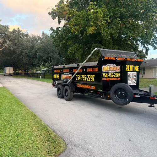 Dumpster rental trailer in a homeowner driveway