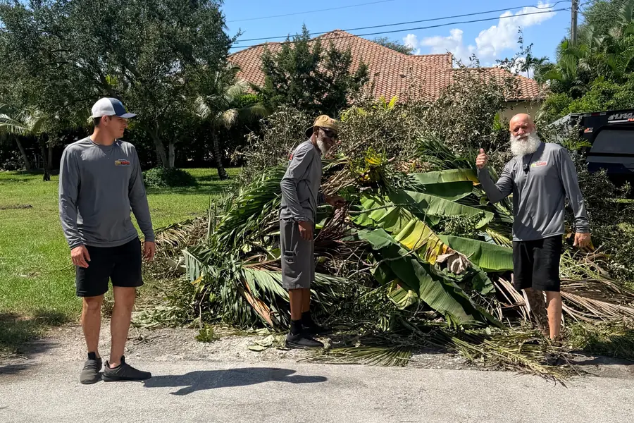 Crew clearing a debris pile during a property cleanout